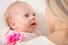 two-month-baby-looking-his-mother-lying-back-bed-sitting-next-to-child-her-62608440